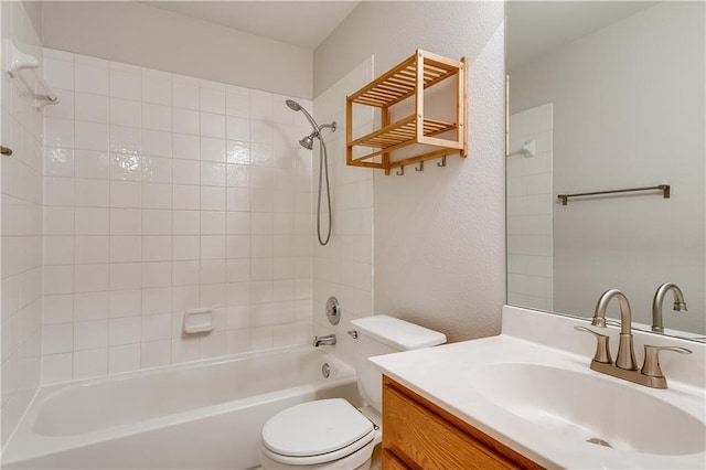 full bath featuring vanity, toilet, shower / bathing tub combination, and a textured wall