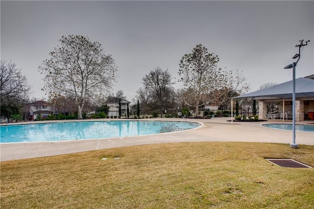 pool featuring a patio and a yard