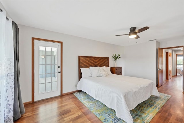 bedroom with visible vents, a ceiling fan, light wood-type flooring, and baseboards