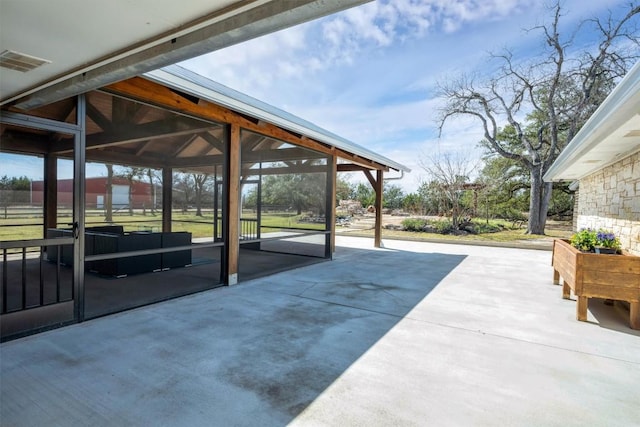 view of patio / terrace with visible vents and a sunroom