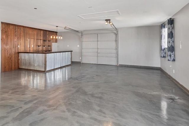 garage with electric panel, baseboards, and wooden walls