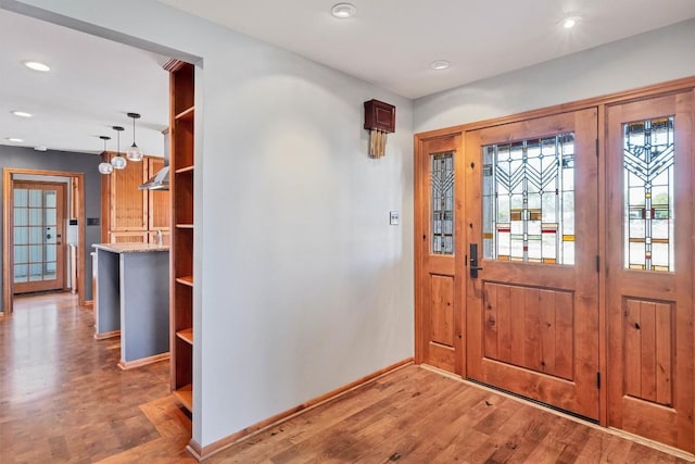 entrance foyer featuring recessed lighting, baseboards, and light wood-style floors