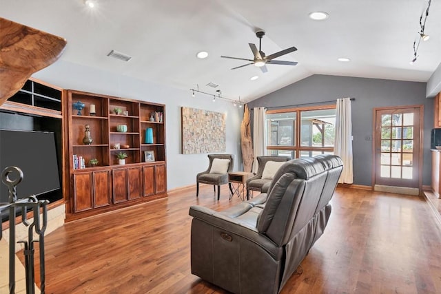 living area featuring a ceiling fan, wood finished floors, visible vents, vaulted ceiling, and rail lighting