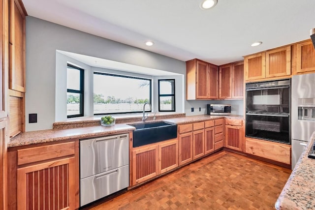 kitchen featuring a sink, appliances with stainless steel finishes, and recessed lighting