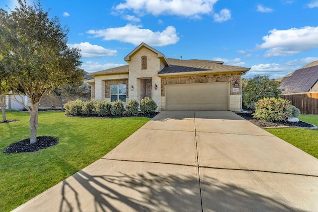 view of front of home featuring brick siding, a front lawn, a garage, stone siding, and driveway