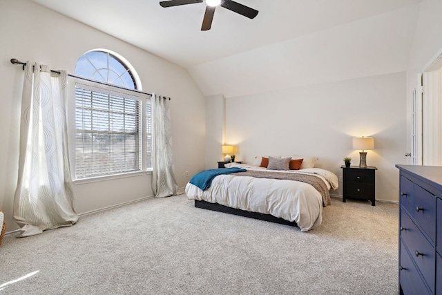 bedroom with a ceiling fan, vaulted ceiling, and light colored carpet