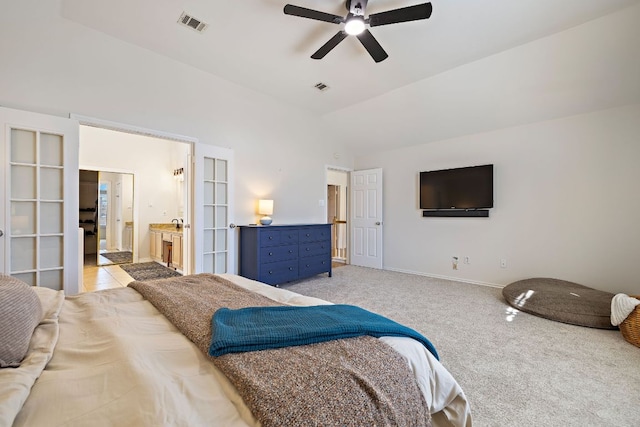 bedroom featuring vaulted ceiling, baseboards, visible vents, and light carpet