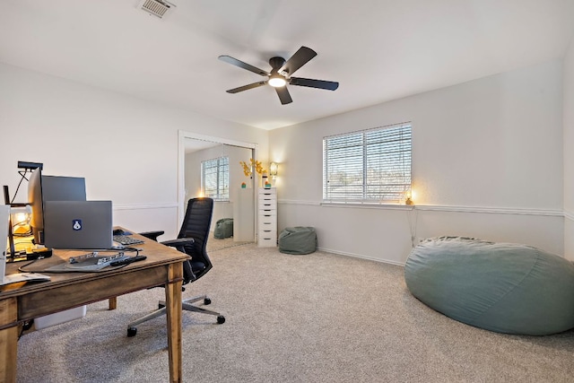 home office featuring visible vents, carpet flooring, and ceiling fan