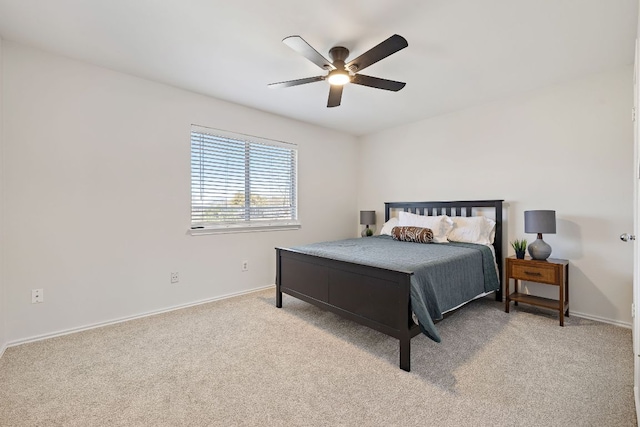 carpeted bedroom with baseboards and a ceiling fan