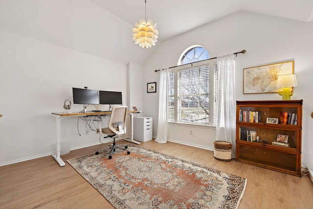 office area with vaulted ceiling, wood finished floors, and baseboards