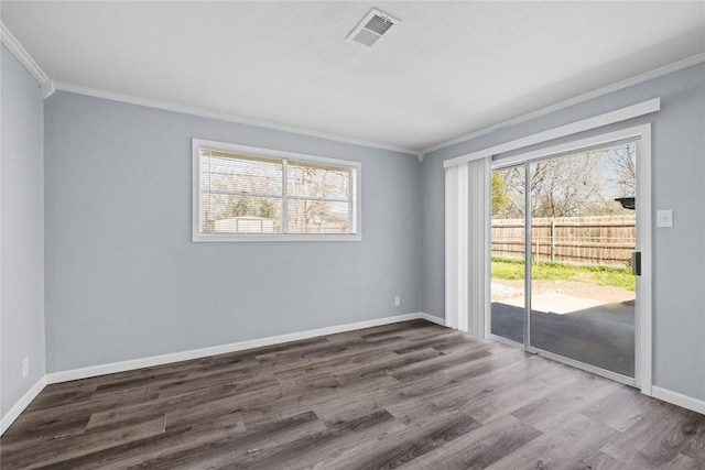 unfurnished room featuring visible vents, a healthy amount of sunlight, dark wood-type flooring, and baseboards