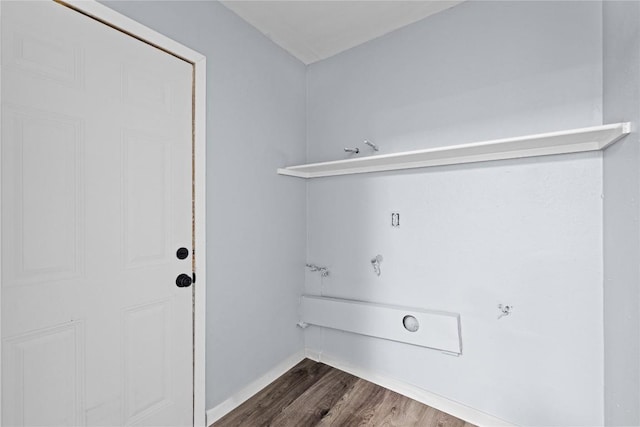 washroom with dark wood finished floors and laundry area