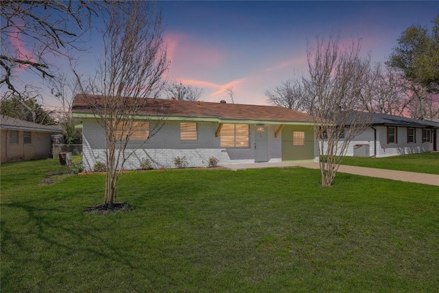 ranch-style home with a front yard and brick siding