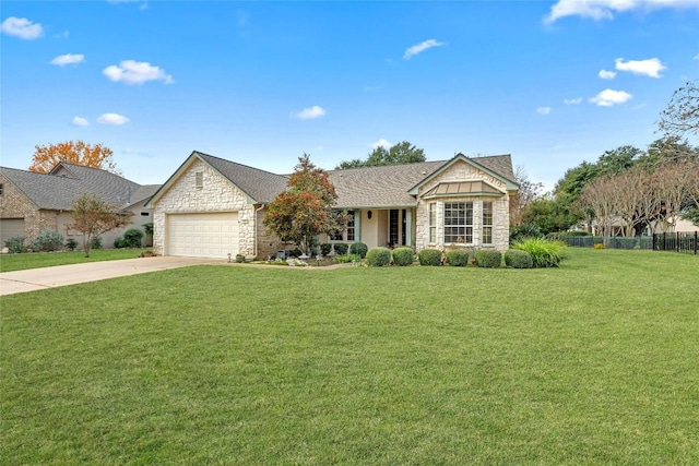 view of front facade with fence, concrete driveway, a front yard, a garage, and stone siding