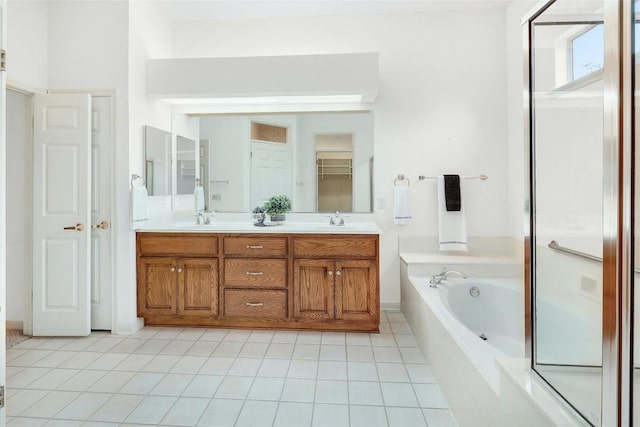 bathroom featuring double vanity, a sink, a shower stall, tile patterned floors, and a bath