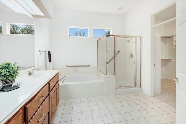 bathroom with vanity, a shower stall, and plenty of natural light