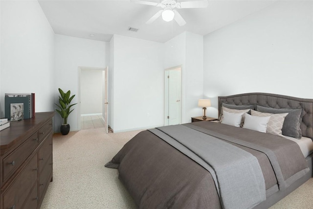 bedroom featuring visible vents, light carpet, baseboards, and ceiling fan