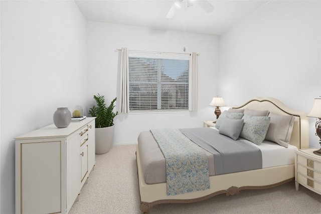 bedroom with a ceiling fan and light colored carpet