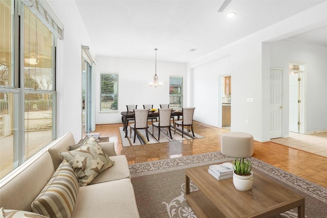 living room with a notable chandelier and baseboards