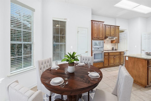 dining space featuring light tile patterned floors