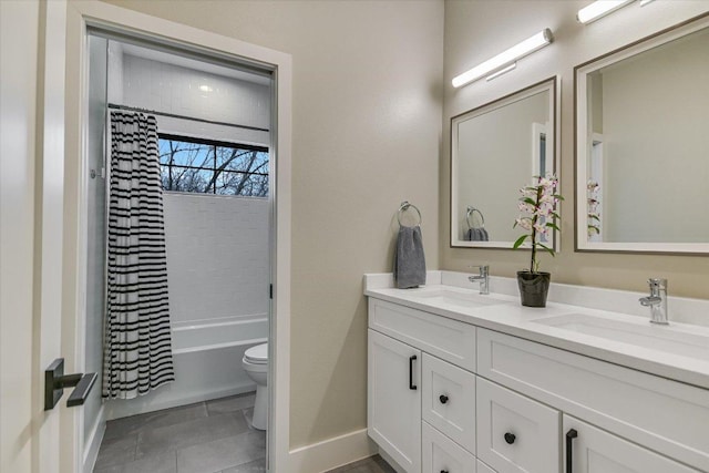 full bathroom featuring tile patterned flooring, double vanity, toilet, and a sink