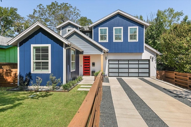 view of front facade with a front lawn, fence, board and batten siding, concrete driveway, and a garage