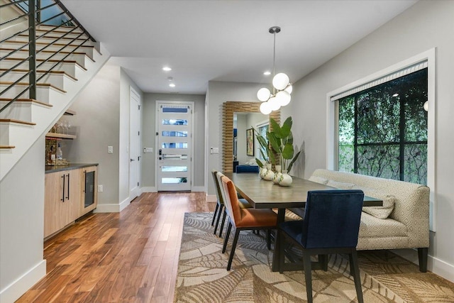 dining area featuring stairway, recessed lighting, baseboards, and wood finished floors