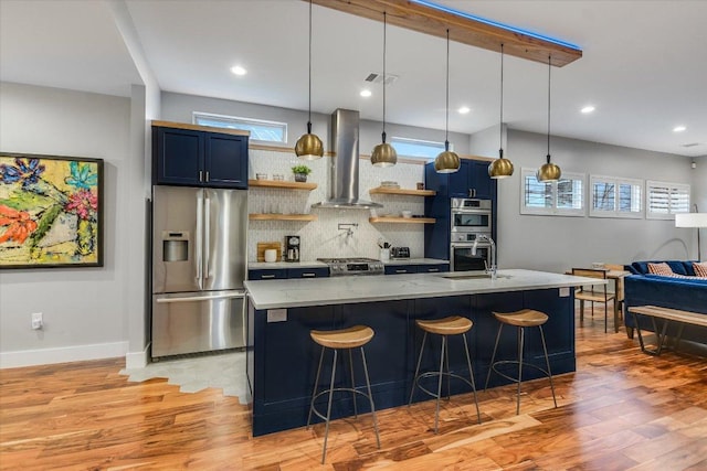 kitchen with visible vents, open shelves, appliances with stainless steel finishes, wall chimney range hood, and blue cabinets