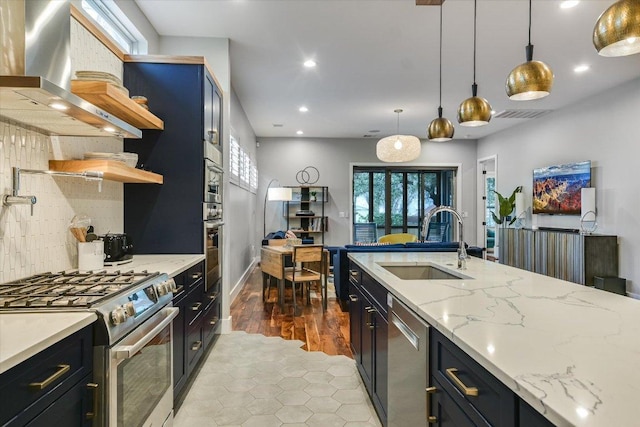 kitchen featuring a sink, open shelves, stainless steel appliances, wall chimney range hood, and decorative backsplash