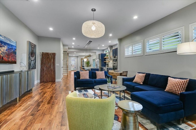 living room featuring recessed lighting, baseboards, and wood finished floors