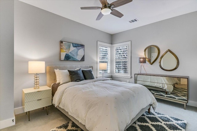 carpeted bedroom featuring visible vents, baseboards, and a ceiling fan