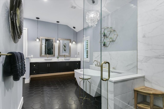 full bathroom featuring lofted ceiling, double vanity, a sink, tile patterned flooring, and a freestanding bath