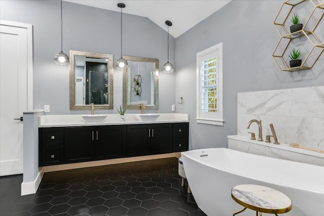 full bathroom with a sink, a freestanding tub, lofted ceiling, and a shower with shower door