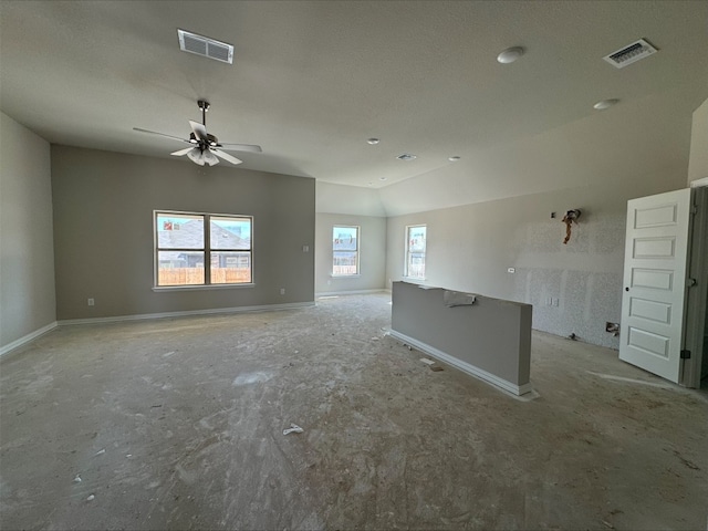 spare room with visible vents, a ceiling fan, baseboards, and vaulted ceiling