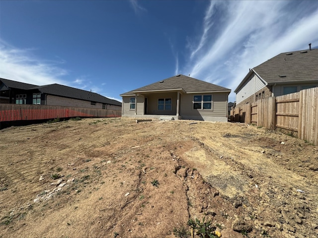 back of house with fence