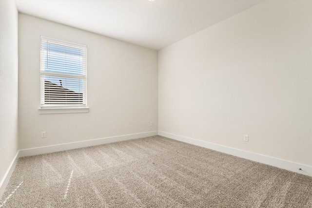 unfurnished room featuring baseboards and carpet floors