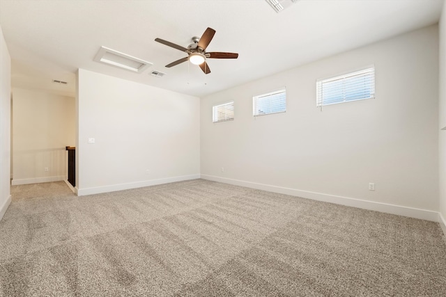 unfurnished room with baseboards, visible vents, light carpet, and attic access