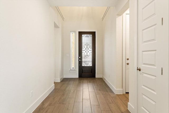 foyer entrance featuring wood finished floors and baseboards