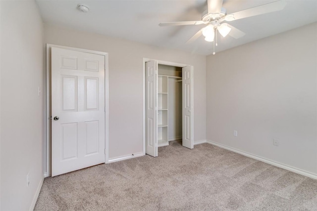 unfurnished bedroom featuring a closet, baseboards, carpet, and a ceiling fan