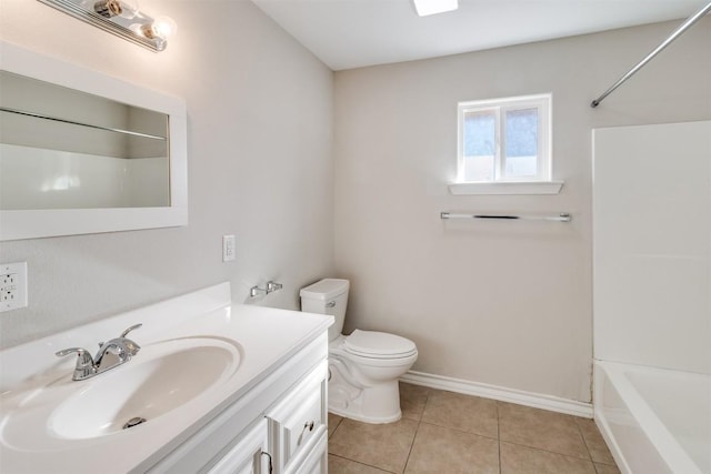 full bath with toilet, tile patterned flooring, tub / shower combination, baseboards, and vanity