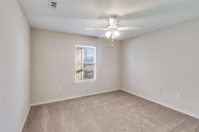 carpeted empty room featuring a ceiling fan, baseboards, and visible vents