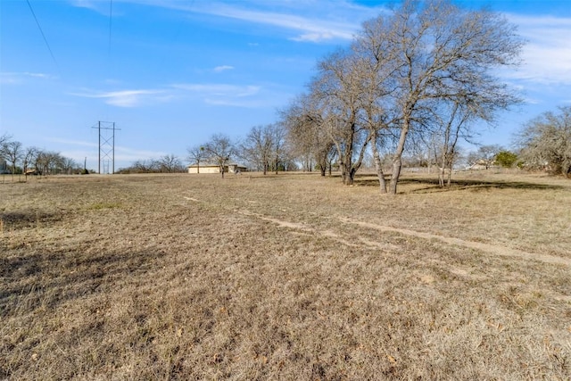 view of yard with a rural view