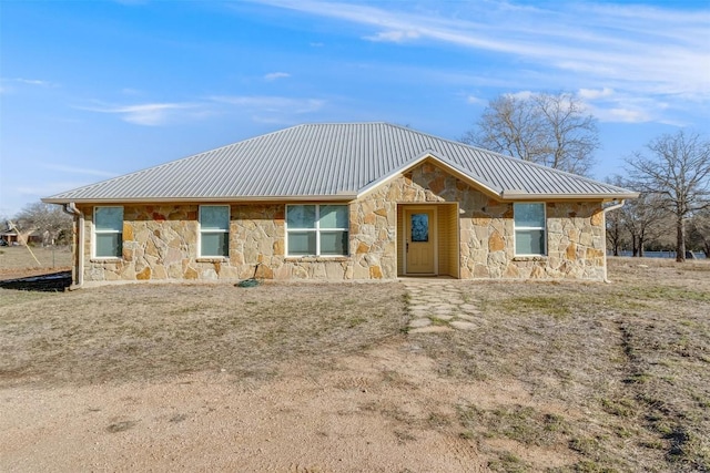 view of front of property with stone siding and metal roof