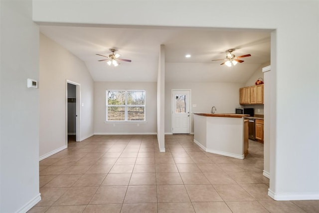 kitchen featuring light tile patterned floors, open floor plan, a ceiling fan, and vaulted ceiling