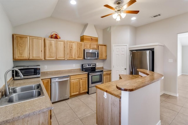 kitchen featuring a sink, stainless steel appliances, visible vents, and light brown cabinets