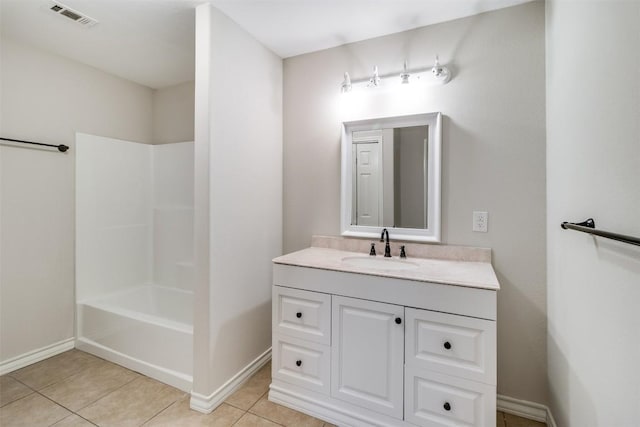 bathroom featuring vanity, visible vents, baseboards, tub / shower combination, and tile patterned flooring