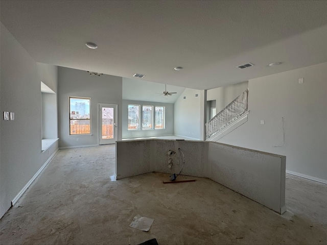 unfurnished living room featuring stairway, a ceiling fan, visible vents, and baseboards