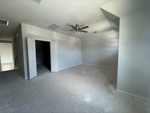 unfurnished bedroom with lofted ceiling, baseboards, and visible vents