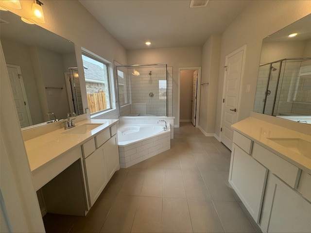 191 Dove Tree Dr, Buda, TX 78610 - bathroom featuring a sink, a stall shower, two vanities, a bath, and tile patterned flooring