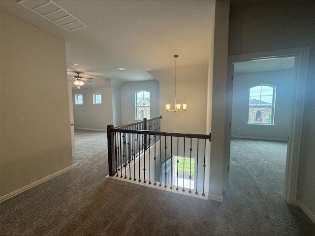 191 Dove Tree Dr, Buda, TX 78610 - hall with an upstairs landing, visible vents, carpet, and baseboards